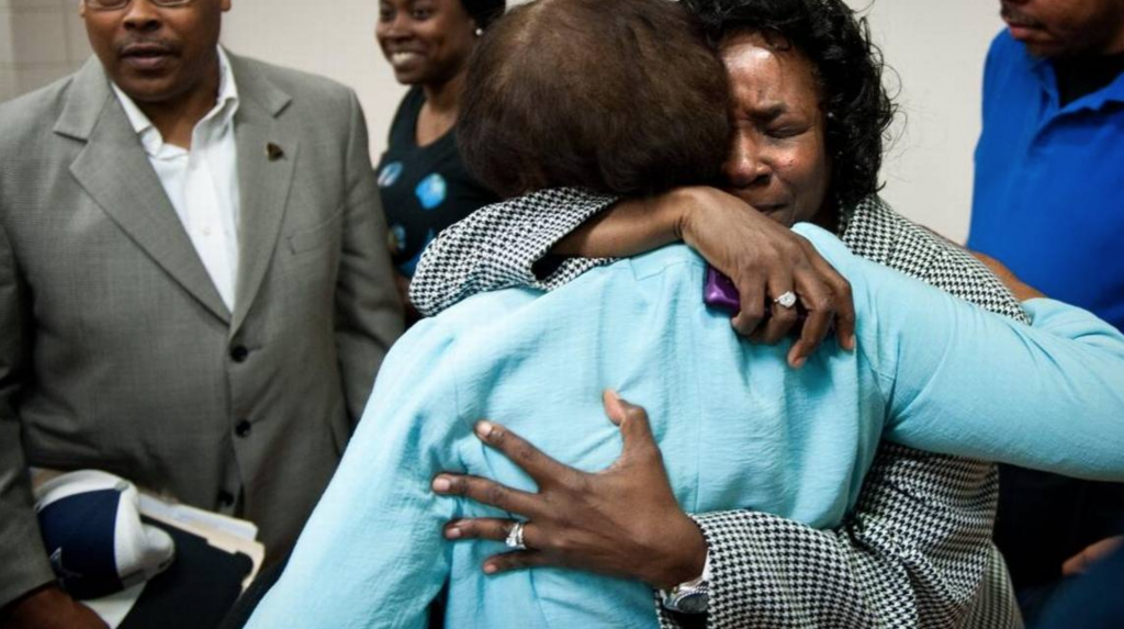Shirley Burns hugs a family friend, when Judge Weeks ruled that her son should be removed from death row and serve a life sentence.
