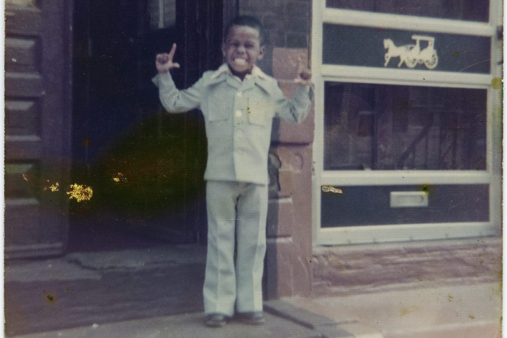A young Nathan Bowie, age 4, smiling on a building's front stoop, in Philadelphia